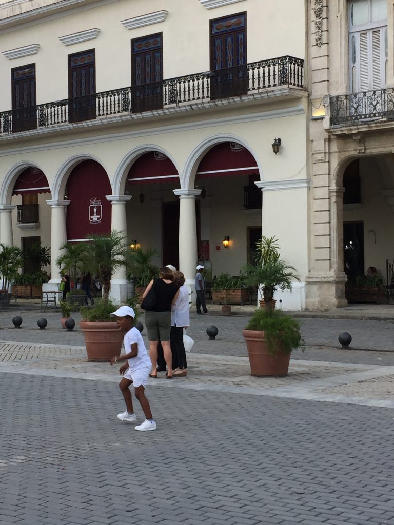 A boy plays soccer in Havana; Mercedes Santana